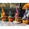 Four little Halloween, witches are decorating a fireplace hearth. Each pumpkin has a different carved face and fall witch hat.